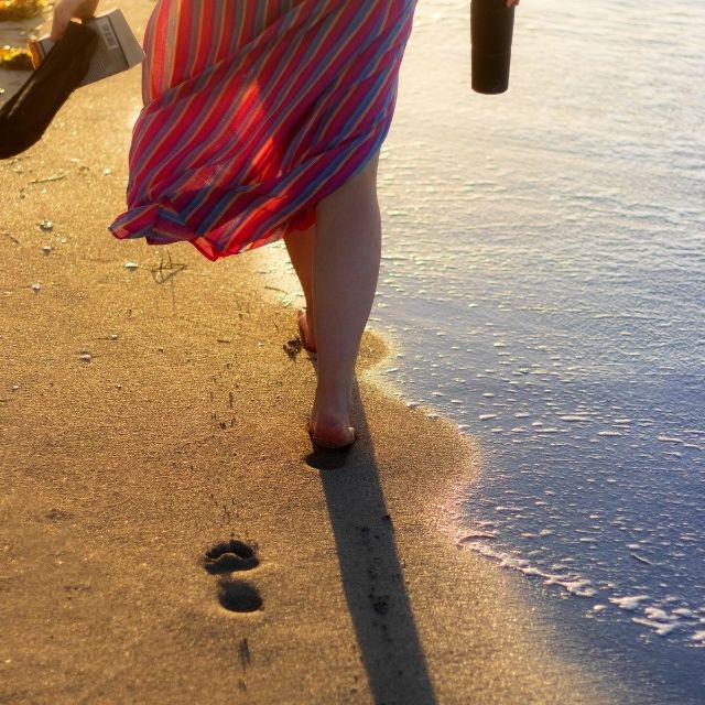 Image of Woman walking in the sand